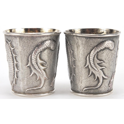 523 - Pair of Chinese silver beakers by Wang Hing, each embossed with a dragon chasing the flaming pearl a... 