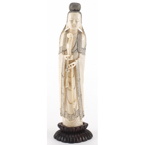 502 - Chinese finely carved ivory okimono of a female wearing a robe on a hardwood stand, 21.5cm high