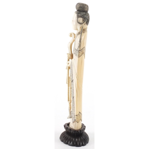 502 - Chinese finely carved ivory okimono of a female wearing a robe on a hardwood stand, 21.5cm high