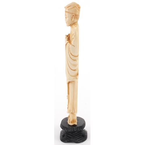 503 - Chinese carved ivory okimono of a gentleman holding a scroll, on hardwood stand, 22cm high