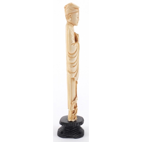 503 - Chinese carved ivory okimono of a gentleman holding a scroll, on hardwood stand, 22cm high