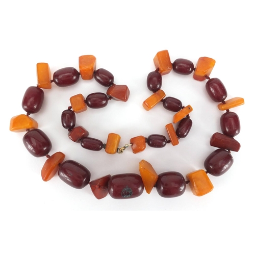 911 - Cherry and butterscotch amber coloured bead necklace, 60cm in length, approximate weight 118.5g