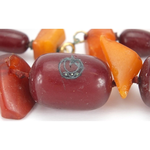 911 - Cherry and butterscotch amber coloured bead necklace, 60cm in length, approximate weight 118.5g