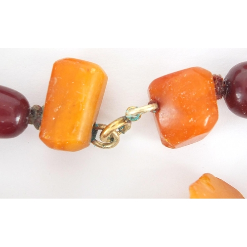 911 - Cherry and butterscotch amber coloured bead necklace, 60cm in length, approximate weight 118.5g