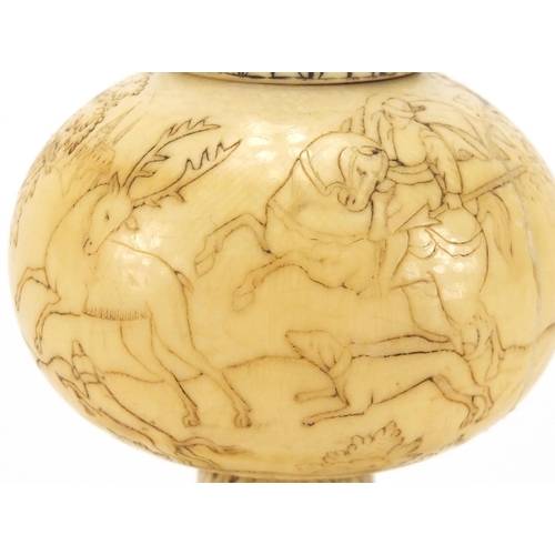 101 - Antique ivory scent bottle engraved with continuous band of figures hunting on horseback, 10cm high