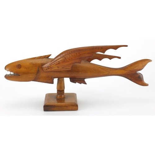 89 - Pitcairn Islands carved wooden flying fish mounted on a wooden stand, 'Greetings from Pitcairn Islan... 