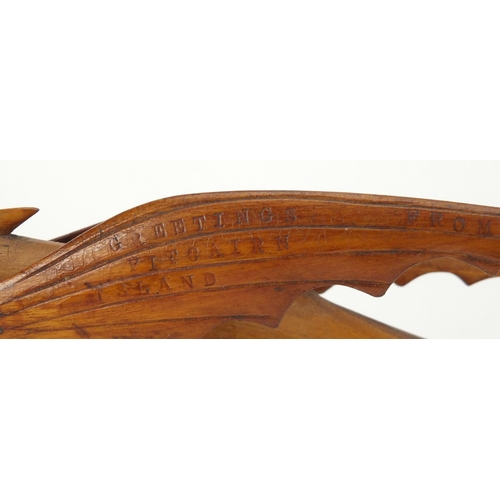 89 - Pitcairn Islands carved wooden flying fish mounted on a wooden stand, 'Greetings from Pitcairn Islan... 