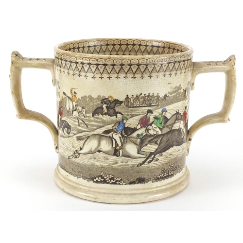 611 - Victorian Staffordshire pottery loving cup transferred printed and hand coloured with a horse racing... 