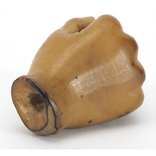 106 - Vegetable ivory walking cane pommel in the form of a well detailed hand clutching a ball, 4cm high