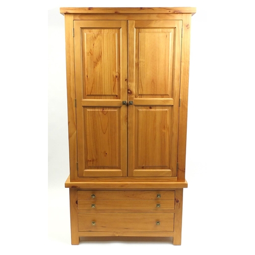 7 - Pine two door wardrobe fitted with two drawers to the base, 203cm H x 105cm W x 57cm D