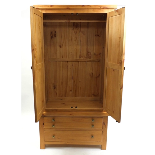 7 - Pine two door wardrobe fitted with two drawers to the base, 203cm H x 105cm W x 57cm D