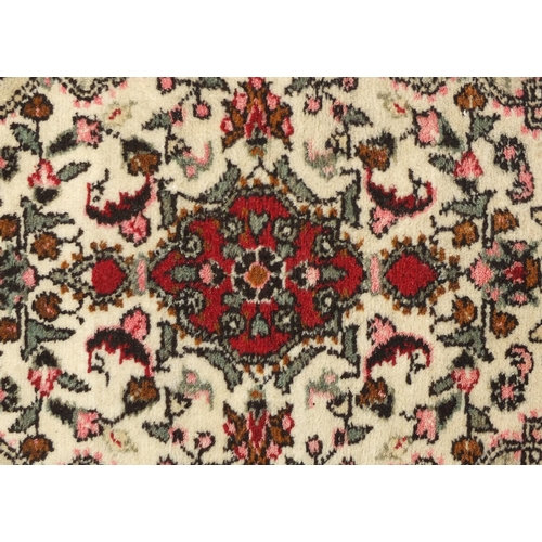 82 - Cream and red ground geometric pattern rug, 76cm x 52cm