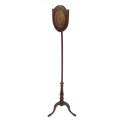 2038 - Victorian mahogany shield shaped face screen on tripod base, paper label to the reverse, 145cm high