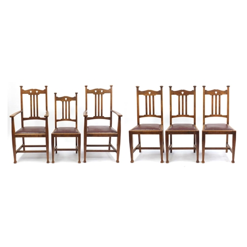 2014 - Set of six oak Arts & Crafts chairs including two carvers with carved heart splats and brown leather... 