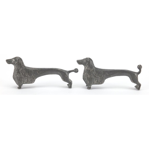 693 - Near pair of Kayserninn /  Kayserzinn  pewter dog knife rests, both numbered 4720, each 9cm in lengt... 