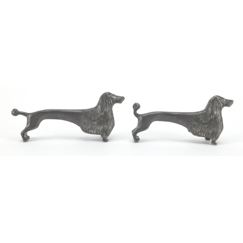 693 - Near pair of Kayserninn /  Kayserzinn  pewter dog knife rests, both numbered 4720, each 9cm in lengt... 