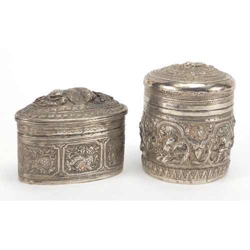 757 - Indian unmarked silver cylindrical pot and cover profusely embossed with figures and foliage, togeth... 