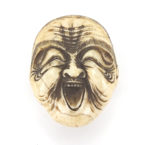 507 - Japanese carved ivory walking stick pommel in the form of a face, 4cm high