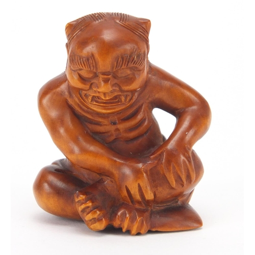 501 - Japanese carved boxwood netsuke of a devil, character marks to the base, 4.3cm high