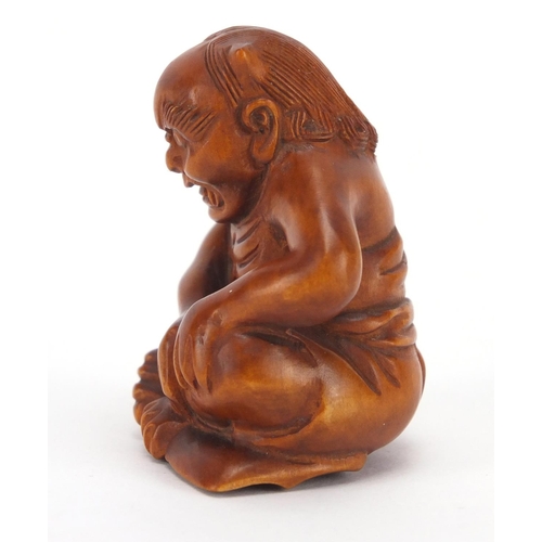 501 - Japanese carved boxwood netsuke of a devil, character marks to the base, 4.3cm high