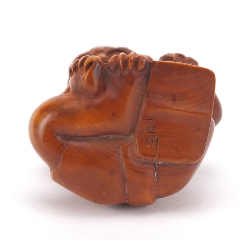 501 - Japanese carved boxwood netsuke of a devil, character marks to the base, 4.3cm high