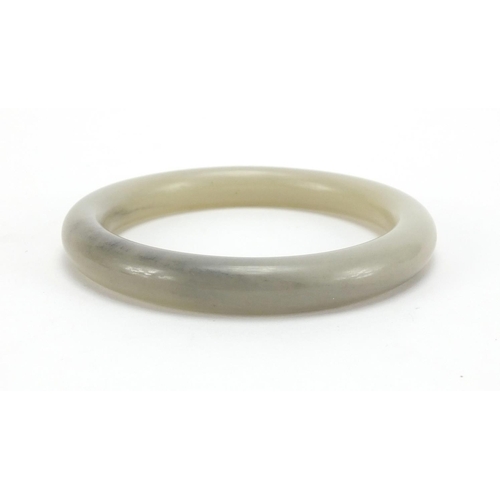 495 - Chinese pale celadon jade bangle, 8.4cm in diameter, approximate weight 56.9g