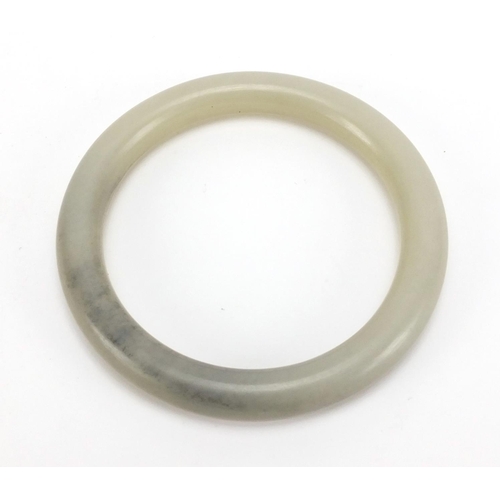 495 - Chinese pale celadon jade bangle, 8.4cm in diameter, approximate weight 56.9g