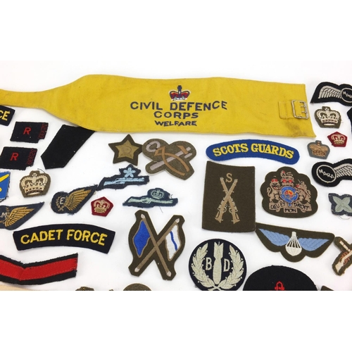 315 - British Military and other cloth insignia and together with a Civil Defence Corps arm band