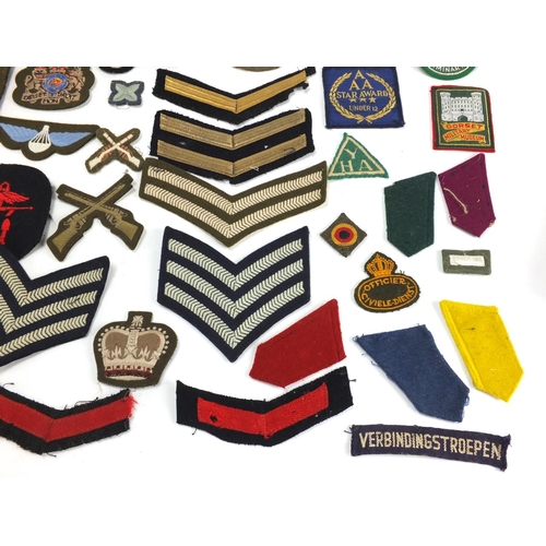 315 - British Military and other cloth insignia and together with a Civil Defence Corps arm band