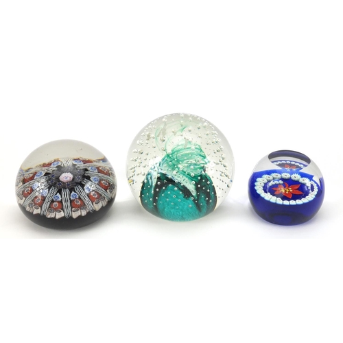 627 - Three colourful glass paperweights comprising one with unpolished pontil and two Caithness, miniatur... 