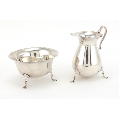 765 - Matching silver three footed milk jug and sugar bowl, MEB FEB Chester 1925, the jug 9.5cm high, appr... 