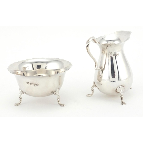 765 - Matching silver three footed milk jug and sugar bowl, MEB FEB Chester 1925, the jug 9.5cm high, appr... 