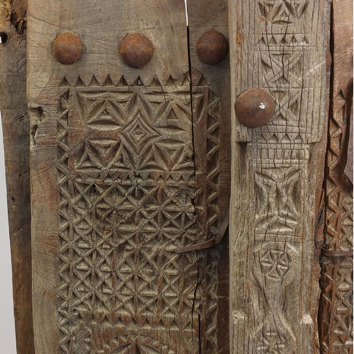 572 - Pair of Indian hardwood and iron shutters, possibly 17th century Gujarati, 155cm high x 120cm wide