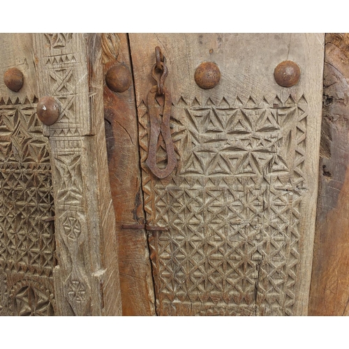 572 - Pair of Indian hardwood and iron shutters, possibly 17th century Gujarati, 155cm high x 120cm wide