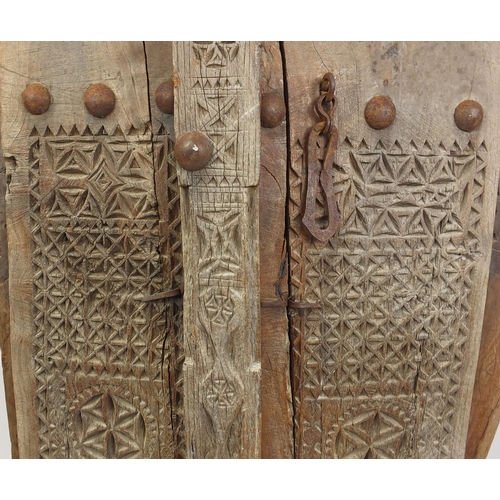 572 - Pair of Indian hardwood and iron shutters, possibly 17th century Gujarati, 155cm high x 120cm wide