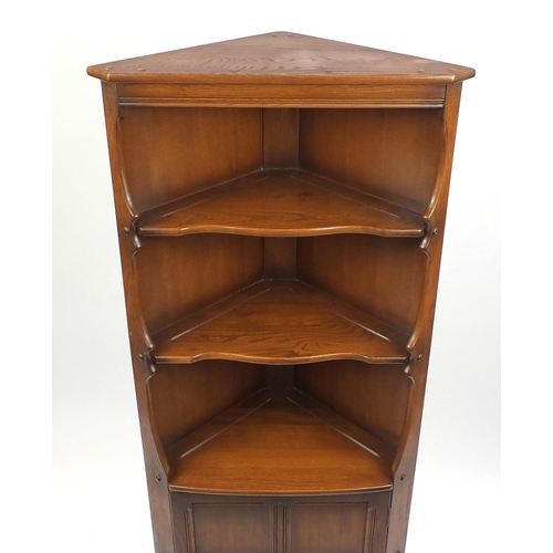 38 - Ercol stained elm standing corner cabinet, 184cm high