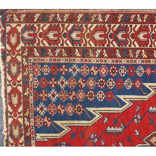 9 - Persian tribal rug, having an all over geometric design onto a blue and red ground, 197cm x 136cm