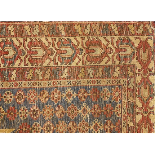 9 - Persian tribal rug, having an all over geometric design onto a blue and red ground, 197cm x 136cm