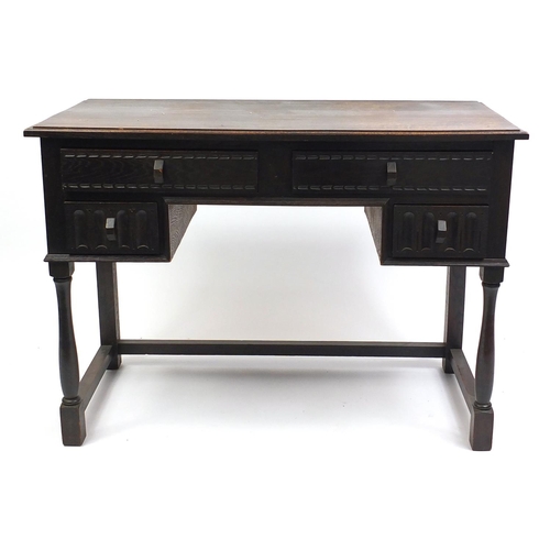 39 - Oak dressing table with an arrangement of four carved  drawers, with label for The Lantern Galleries... 
