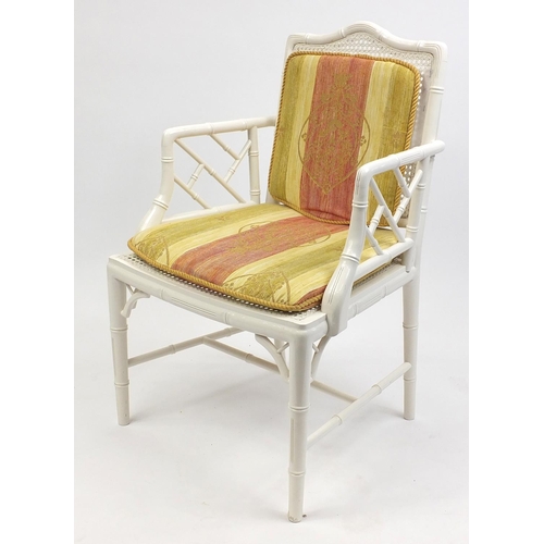 64 - Simulated bamboo elbow chair with cane back and seats and removable cushions