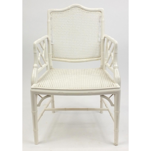 64 - Simulated bamboo elbow chair with cane back and seats and removable cushions