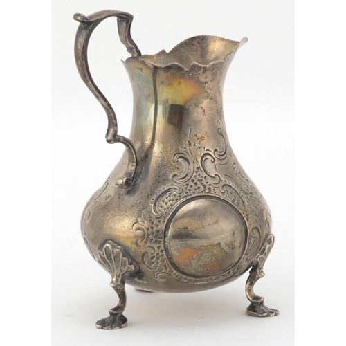 746 - Victorian silver three footed milk jug, D.H C.H, London 1860 10cm high, approximate weight  100.4g