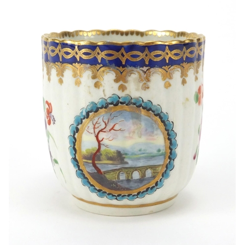 599 - 19th Century Royal Worcester fluted porcelain cup, the centre hand painted with a panel of a bridge ... 