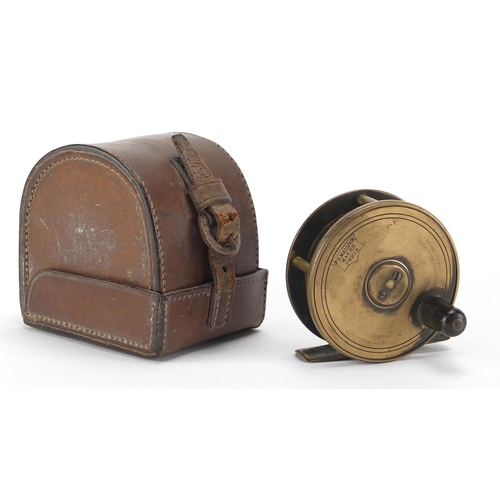 136 - Victorian brass fishing reel by P D Malloch maker of Perth, with leather case, 6.5cm in diameter