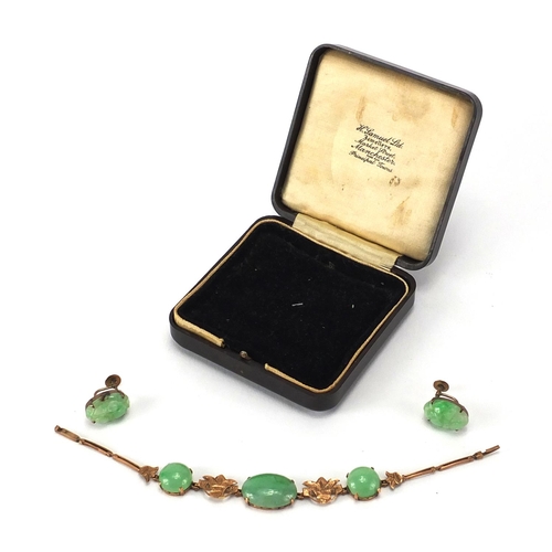 489 - Chinese green jade and unmarked gold suite comprising a pair of earrings, carved with flowers and a ... 