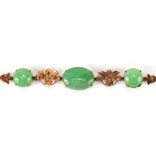 489 - Chinese green jade and unmarked gold suite comprising a pair of earrings, carved with flowers and a ... 