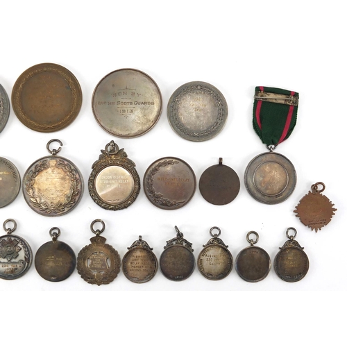 316 - Military interest sporting jewels and medallions, some silver including The Army Rifle Association, ... 