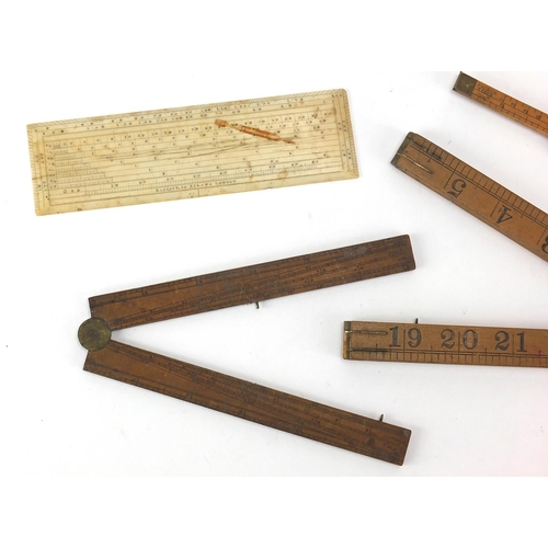 122 - Four antique and later rulers, three boxwood and one ivory including a Rabone with protractor and an... 