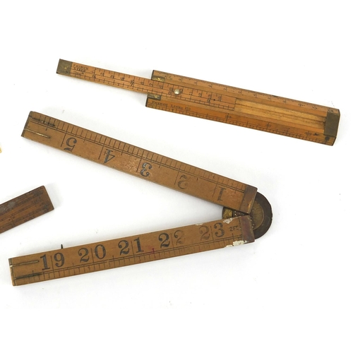 122 - Four antique and later rulers, three boxwood and one ivory including a Rabone with protractor and an... 