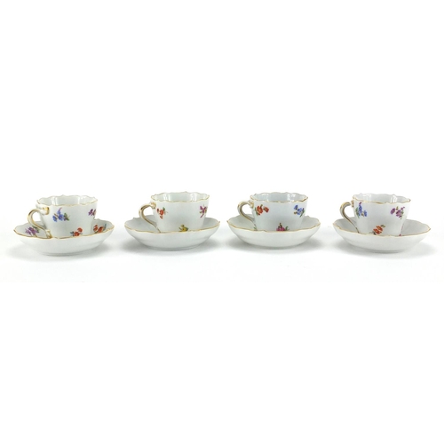 583 - Four Meissen tea cups and saucers, each hand painted with flowers and with crossword marks to the ba... 